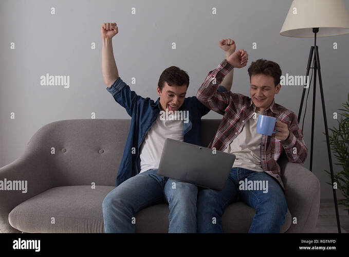 two-guys-with-laptop-on-sofa-RGTMFD